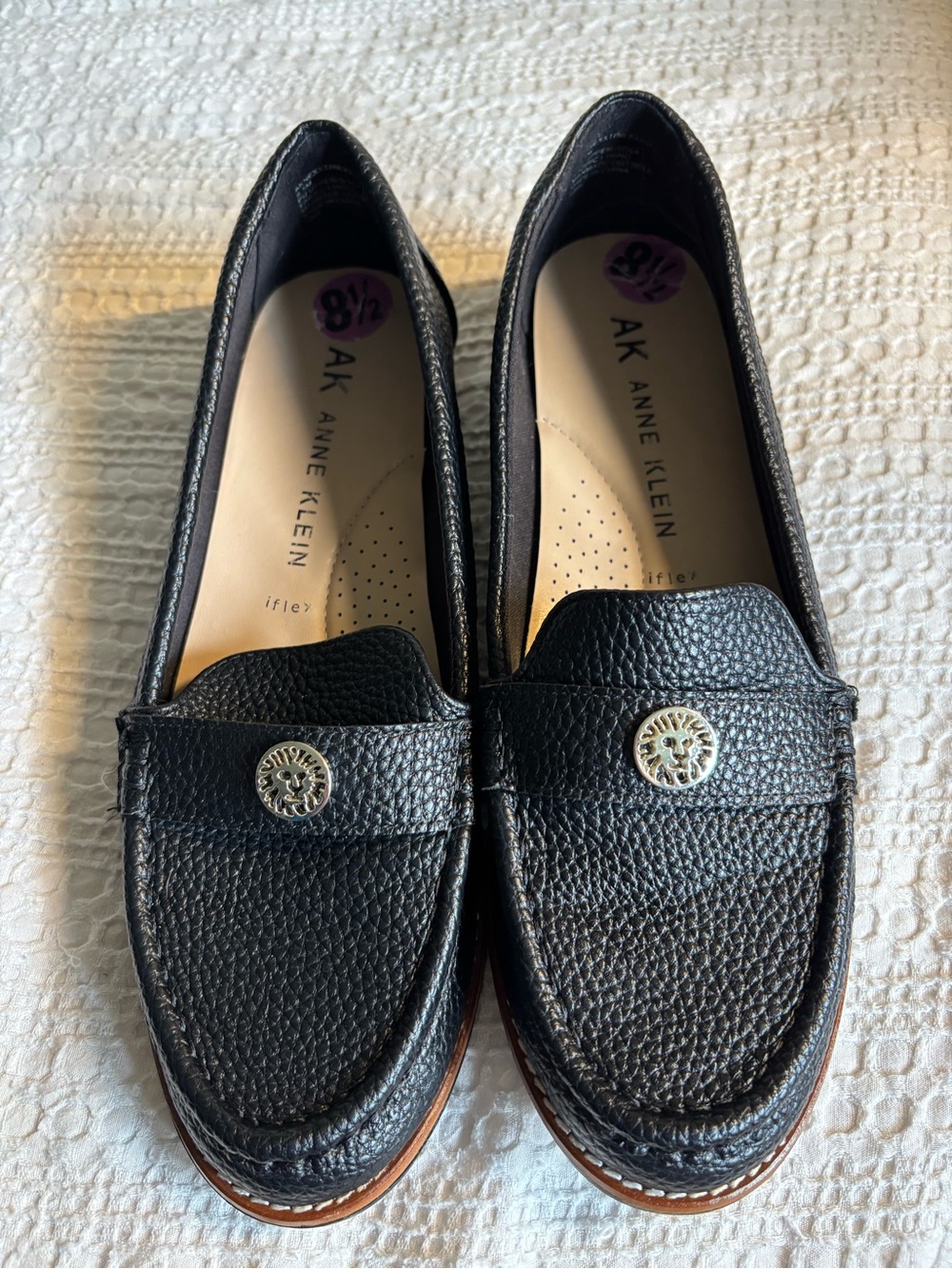 Anne Klein Black Pebbled Leather Penny Loafers with Gold Emblem